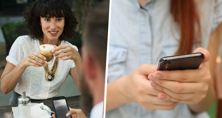 Kvinna med kaffe kollar på kille som håller i telefon, hand som håller i telefon